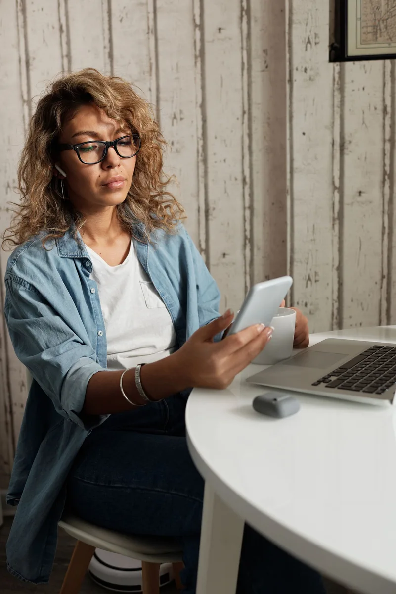 A person completes a short eligibility form on a smartphone at home.